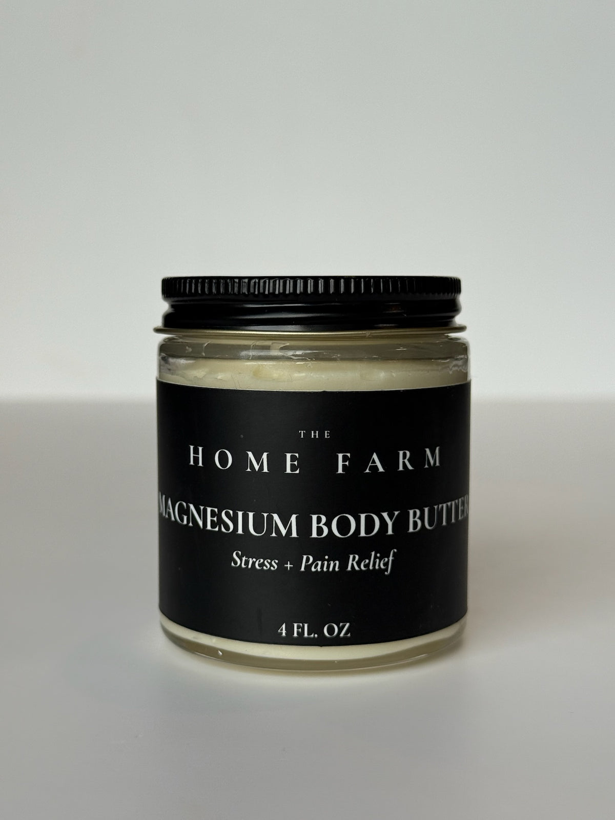 Mantequilla corporal de magnesio de DC-The Home Farm, crema hidratante con ingredientes naturales en envase elegante.