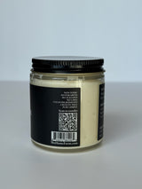 Crema corporal de magnesio de DC-The Home Farm mostrando la textura cremosa en un frasco blanco.